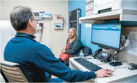  ?? ?? Dr. Manuel Vazquez, Urban Health Plan’s vice president of medical affairs, speaks with a patient at El Nuevo San Juan Health Center in the Bronx borough of New York City.