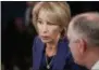  ?? CAROLYN KASTER—ASSOCIATED PRESS ?? Education Secretary Betsy DeVos, talks with Louisiana Gov. John Bel Edwards before President Donald Trump arrives to speak at the 2019White House Business Session with Our Nation’s Governors in the State Dining Room of the White House in Washington, Monday, Feb. 25, 2019.