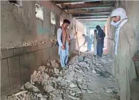  ?? SIDIQULLAH KHAN/AP ?? Damage is inspected in a mosque after a suicide bombing attack Friday in Kandahar, Afghanista­n.