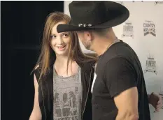  ??  ?? Kelsey Klein gets a chance to meet Aaron Pritchett during the CCMA Fanfest show at Prairielan­d Park Saturday.