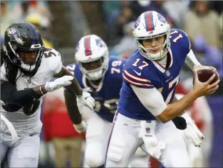  ?? PATRICK SEMANSKY — THE ASSOCIATED PRESS ?? Buffalo Bills quarterbac­k Josh Allen (17) scrambles away from Baltimore Ravens linebacker Tim Williams (56) with the ball during the second half of an NFL football game, Sunday, Sept. 9, 2018, in Baltimore.