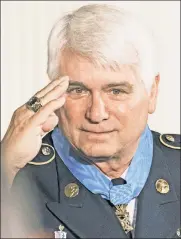  ??  ?? Long overdue: President Trump awarded former Army medic James McCloughan the Medal of Honor.