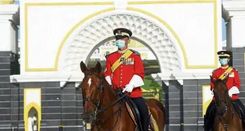  ?? — AZHAR MAHFOF/THE Star ?? Royal guards riding horses at the main gate of Istana negara for the swearing-in ceremony for Tan Sri Muhyiddin yassin as prime minister on March 1.