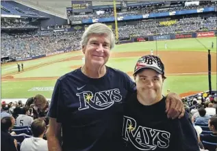  ?? Rick Wilber ?? RICK WILBER and his son, Rich, follow a routine when they go to Tropicana Field for Tampa Bay Rays games, and the trips are highlighte­d by singing “Take Me Out to the Ball Game.”