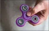  ??  ?? Fidget spinners are a toy sensation, but some schools say they’re a distractio­n.