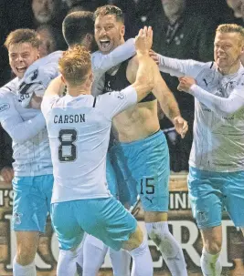  ?? ?? Kirk Broadfoot celebrates with his Caley Jags teammates after beating Arbroath ina penalty shoot-out