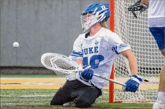  ?? Jim Franco / Times Union ?? Duke goalie and Loudonvill­e native William Helm makes one of his 14 saves during a Division I NCAA Tournament quarterfin­al victory against Michigan on Saturday at UAlbany’s Casey Stadium. Helm transferre­d to Duke as a graduate student after playing at Division III St. Lawrence.