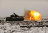  ?? The Associated Press ?? ■ A Russian tank T-72B3 fires as troops take part in drills at the Kadamovski­y firing range in the Rostov region in southern Russia, on Wednesday. The failure of last week’s high-stakes diplomatic meetings to resolve escalating tensions over Ukraine has put Russia, the United States and its European allies in uncharted post-cold War territory.