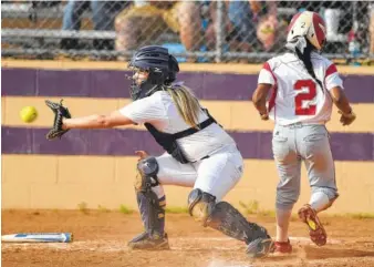  ?? STAFF PHOTO BY ANGELA LEWIS FOSTER ?? Central’s Kerri Sylvester waits for the ball as Tiera Lemon crosses the plate Monday at Central High School.