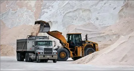  ?? NANCY LANE — BOSTON HERALD ?? Trucks fill up with road salt at Chelsea’s Eastern Salt on Monday.