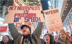  ??  ?? People in New York City demonstrat­e in support of the current Net-neutrality regulation­s last Thursday. MARY ALTAFFER/AP