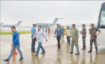  ?? H ?? Passengers disembark from Indian Air Force's C17 Globemaste­r at Hindon Air Force Station after being evacuated from Kabul ami the Taliban takeover crisis in Ghaziabad on August 21.