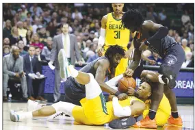  ?? (AP/Rod Aydelotte) ?? Baylor forward Freddie Gillespie (center) grabs a rebound between Oklahoma State forward Kalib Boone (left) and guard Isaac Likekele (right) during the first half on Saturday in Waco, Texas.