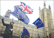  ?? AP PHOTO ?? Demonstrat­ors opposing Brexit wave flags as the European Commission’s Chief Negotiator for the U.K., Michel Barnier, exits the European Union.