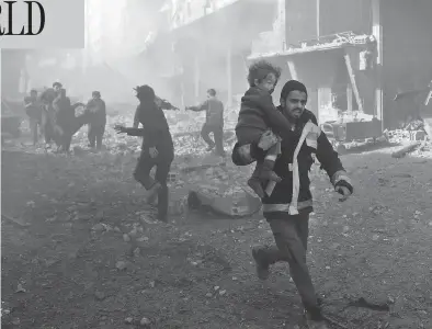  ?? ABDULMONAM EASSA / AFP / GETTY IMAGES ?? A man rescues an infant after a bombing raid on the outskirts of the Syrian capital Damascus on Sunday. At least 71 people were killed and more than 300 were injured in 24 hours of intense bombing in eastern Ghouta, observers said.