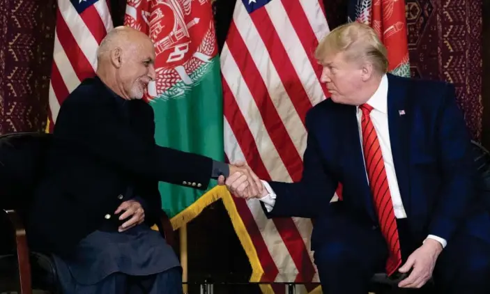  ??  ?? Donald Trump shakes with Afghan president Ashraf Ghani at Bagram. Photograph: Alex Brandon/AP