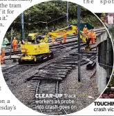  ??  ?? CLEAR-UP Track workers as probe into crash goes on TOUCHING