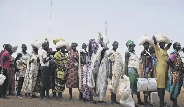  ?? PICTURE: AP ?? 0 Women queue for food in South Sudan where more than 100,000 people in two counties of Unity state are experienci­ng famine