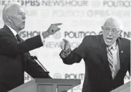  ?? CHRIS CARLSON/AP ?? Democratic candidates Joe Biden, left, and Bernie Sanders face off in the presidenti­al primary debate Dec. 19 in Los Angeles.