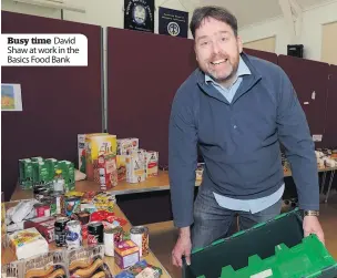  ??  ?? Busy time David Shaw at work in the Basics Food Bank