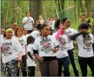  ?? MICHILEA PATTERSON — DIGITAL FIRST MEDIA ?? People line dance on the Schuylkill River Trail at Riverfront Park in Pottstown before participat­ing in the local YWCA Race Against Racism 5K on Saturday morning.