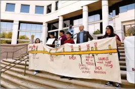  ?? ASSOCIATED PRESS ?? IN THIS PHOTO TAKEN OUTSIDE THE ARIZONA STATE SUPREME COURT in Phoenix on Monday, immigrant students with deferred deportatio­n status hold a banner in support of asking the Supreme Court to rule in favor of continuing their access to in-state tuition...