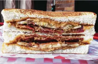  ?? Photos by Chuck Blount / Staff ?? The Elvis, made with sliced bananas and bacon, is a signature sandwich at PB&J with Tay.