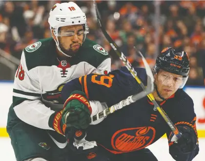  ?? IAN KUCERAK ?? Edmonton Oilers’ Alex Chiasson (39) battles Minnesota Wild’s Jordan Greenway (18) during first period NHL action at Rogers Place in Edmonton, on Friday, Feb. 21, 2020.