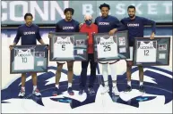  ?? David Butler II / Associated Press ?? From left, UConn’s Brendan Adams (10), Isaiah Whaley (5), coach Dan Hurley, Josh Carlton (25) and Tyler Polley (12) are recognized during senior day ceremonies Saturday.