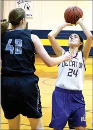  ?? Photo by Mike Eckels ?? Decatur’s Haley Shaffer (24) shoots as Rachel Cox (42) defends during the Lady Bulldog-Lady Cougar junior high game at Peterson Gym in Decatur on Nov. 6. Decatur lost to New School, 26-10.
