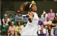  ?? Kirsty Wiggleswor­th / Associated Press ?? Naomi Osaka returns to Yulia Putintseva on day one of Wimbledon in 2019.