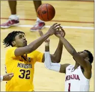  ?? DARRON CUMMINGS — THE ASSOCIATED PRESS ?? Minnesota’s Sam Freeman and Indiana’s Al Durham battle for a rebound during the first half Feb. 17in Bloomingto­n, Ind.
