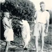  ??  ?? FISHY SNAP: Eldred Bradfield and his dad, Granville Bradfield, holding up a black musselcrac­ker at Granville’s Gully at the Fish River in the ’50s