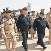  ?? OFFICE OF IRAQI PRIME MINISTER HAIDER AL- ABADI ?? Iraqi Prime Minister Haider alAbadi ( in black cap) arrives inMosul to celebrate the win against ISIS after a lengthy battle.