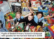  ??  ?? Pupils of Redhill Primary School in Ockbrook with goodies for the harvest festival in 2008