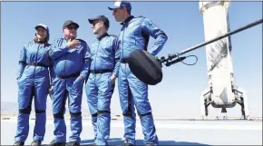  ?? Mario Tama / Getty Images ?? Star Trek actor William Shatner, 90, second from left, with fellow crew members on the landing pad of Blue Origin’s New Shepard spacecraft after flying into space Wednesday, near Van Horn, Texas.