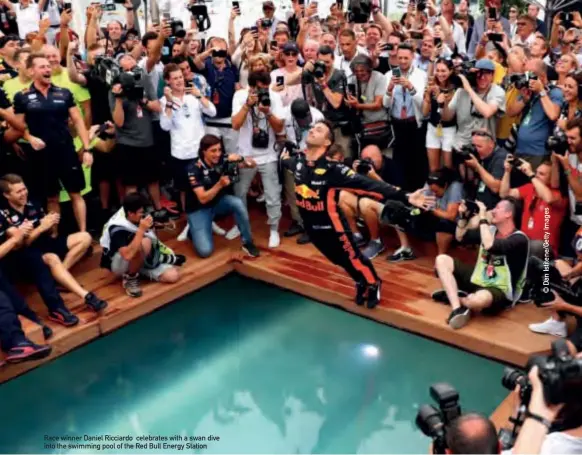  ??  ?? Race winner Daniel Ricciardo celebrates with a swan dive into the swimming pool of the Red Bull Energy Station