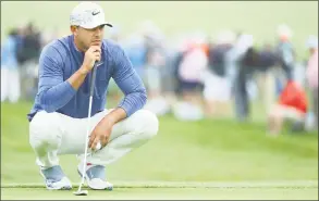  ?? Warren Little / Getty Images ?? Brooks Koepka lines up a putt during the first round of the U.S. Open at Pebble Beach Golf Links on Thursday.