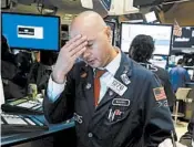  ?? RICHARD DREW/AP ?? Specialist Mario Picone works on the floor of the New York Stock Exchange as the markets plummet Wednesday.