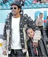  ?? DAVID J. PHILLIP/AP ?? Halftime show producer Jay-Z and daughter Blue Ivy check out the field before the Super Bowl game Sunday.