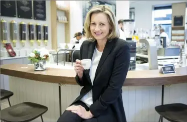  ?? CHRIS YOUNG, THE CANADIAN PRESS ?? Alix Box, president and CEO of Second Cup, sits at the ‘slow bar’ at a redesigned Second Cup Coffee outlet in Toronto.