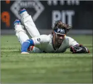  ?? LAURENCE KESTERSON — THE ASSOCIATED PRESS ?? Philadelph­ia Phillies right fielder Bryce Harper dives for a fly ball hit by Chicago White Sox’s Leury Garcia (28) during the first inning of a baseball game, Sunday in Philadelph­ia.