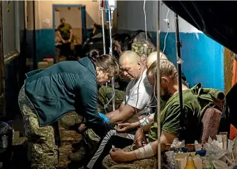  ?? GETTY IMAGES ?? Ukrainian soldiers receive treatment at a frontline field hospital in the eastern city of Popasna yesterday. Russia’s assault on Ukraine has recently focused on the eastern Donbas region, but it has stepped up its attacks on southern cities and ports.