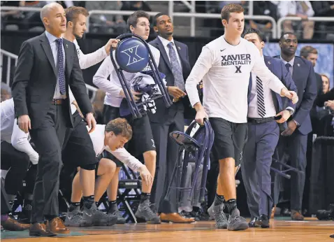  ?? KYLE TERADA, USA TODAY SPORTS ?? Xavier players and assistant coaches bring chairs onto the court for a media timeout in the West Region final in San Jose.