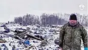  ?? ASSOCIATED PRESS ?? A Russian Investigat­ive Committee employee walks Friday in a place with wreckage from the Russian military Il-76 plane that crashed the previous day in the Yablonovo, Belgorod region of Russia.