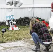  ?? TOM REEL / SAN ANTONIO EXPRESS-NEWS ?? A woman weeps at a memorial Friday in Schertz where a boy, 6, was killed by a stray bullet when deputies opened fire on a wanted woman.