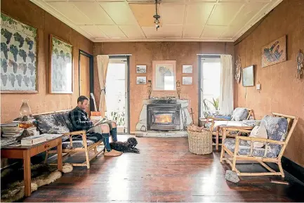  ??  ?? Terence relaxing in the sitting room of their beach house, where there was plenty of time for reflection and silence.