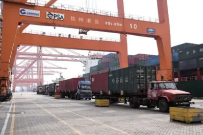  ??  ?? Vehicles move goods at the container wharf of Qinzhou Port in Guangxi Zhuang Autonomous Region in south China, on November 23, 2019