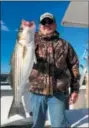  ??  ?? Tatum with nice rockfish caught aboard the Big Worm charter boat this fall on the Chesapeake Bay’s Western Shore. (Courtesy Tom Tatum)