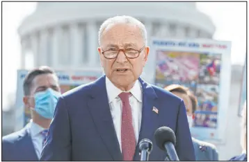  ?? J. Scott Applewhite The Associated Press ?? Senate Majority Leader Chuck Schumer, D-N.Y., joins advocates for Puerto Rico at the Capitol on Monday. Schumer said it was “extremely disappoint­ing ” that the Senate’s nonpartisa­n parliament­arian ruled Democrats can’t use their $3.5 trillion budget package to give millions of immigrants a chance to become citizens.